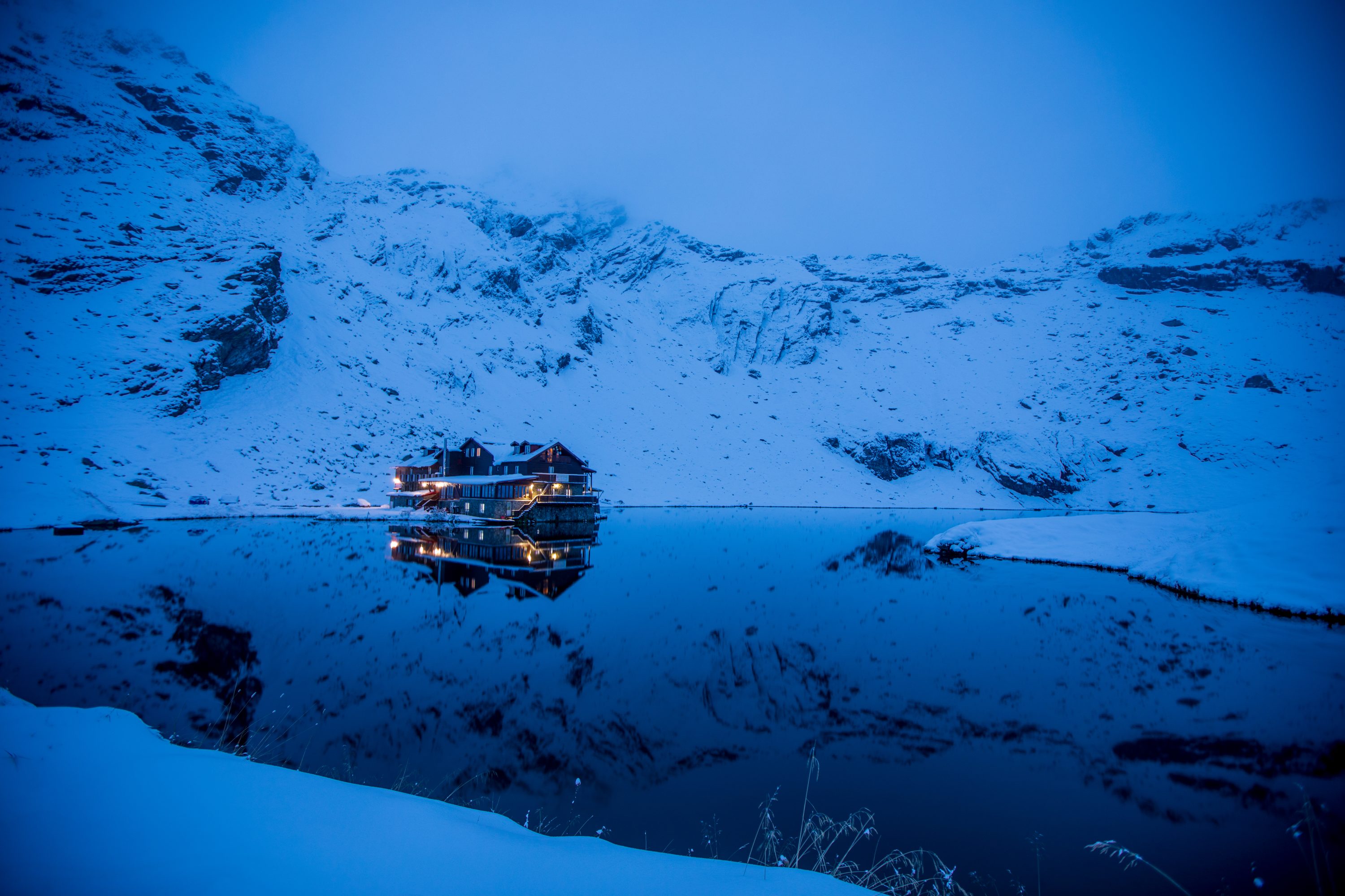 early morning blue hour beautiful balea lake in romania in snow