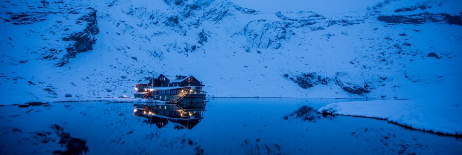 early morning blue hour beautiful balea lake in romania in snow
